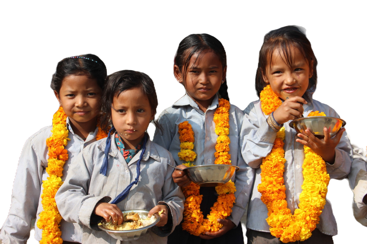Four members of the child-club assembly hold their plates of khichdi and ceremonial marigold garlands after the morning gathering.